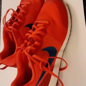 Orange and red Nike shoes
